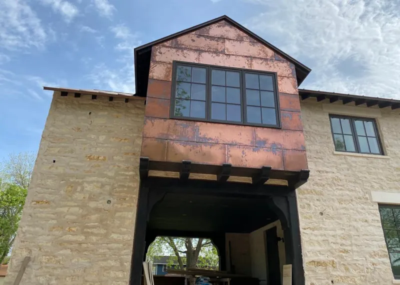 Copper metal panel facade on a stone building for Roof Repair in Bayou Cane